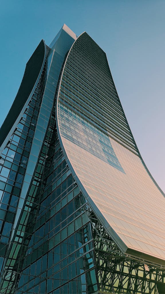 A contemporary curved skyscraper reaching towards the sky, showcasing modern architectural design.
