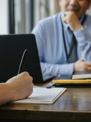 Photo by Sora Shimazaki Crop anonymous female filling questionnaire when applying for job sitting in employer office